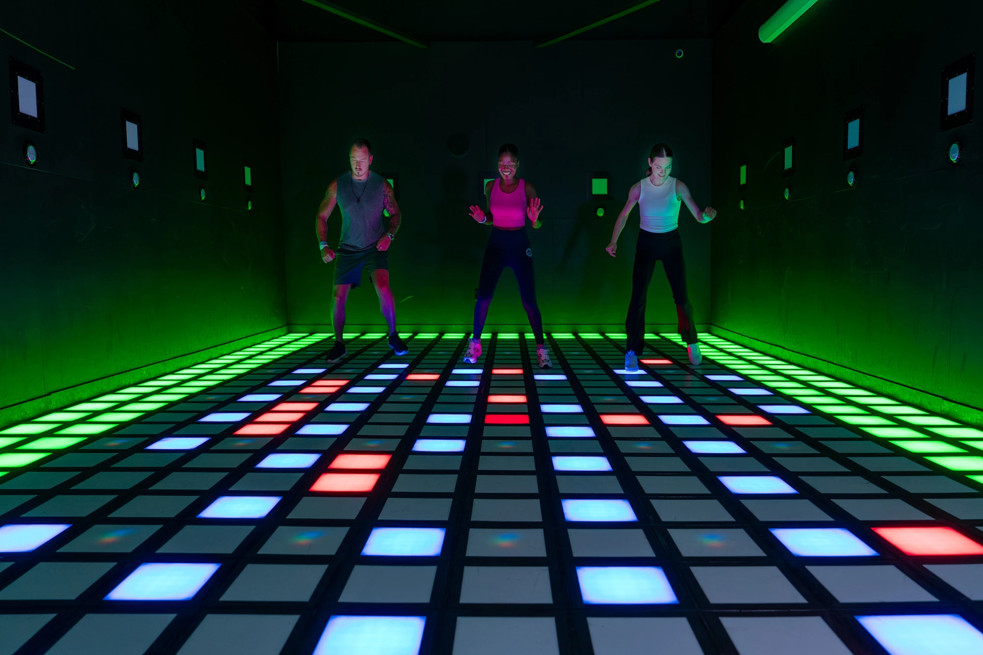 Players on an illuminated interactive game floor